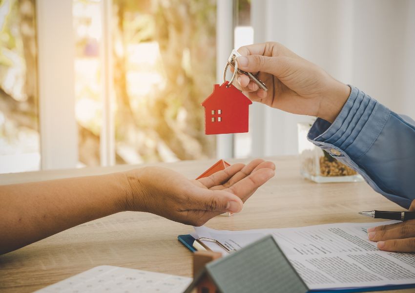 handing-key-with-keychain-to-someone